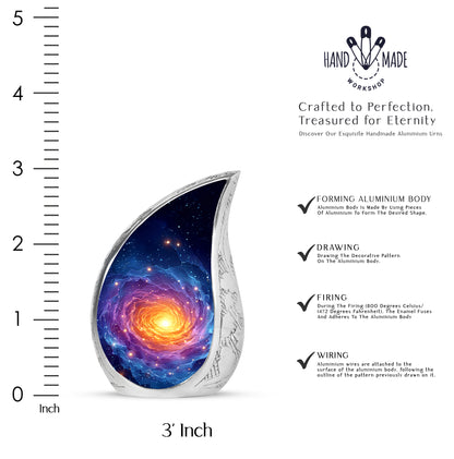 Misty Blue Galaxy Cremation Urn angled view of lid and engraved motif - flowing teardrop galaxy silhouette on curved aluminum - mini keepsake memorial for portion of cremation ashes