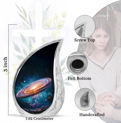 Dark Black Galaxy Cremation Urn angled view of lid and engraved motif - smooth teardrop contour featuring galaxy art - mini keepsake memorial for portion of cremation ashes