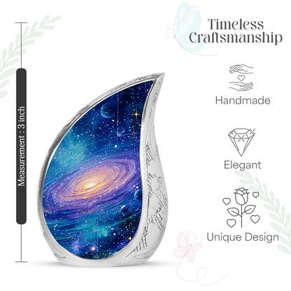 Celestial Blue Galaxy Cremation Urn angled view of lid and engraved motif - rounded teardrop galaxy design with delicate detail - mini keepsake memorial for portion of cremation ashes