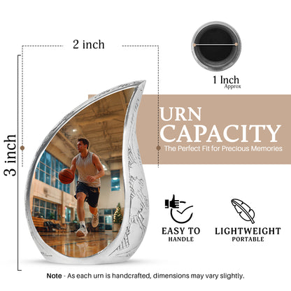 Harvest Gold Basketball Cremation Urn angled view of lid and engraved motif - graceful tear-shaped urn with basketball motif - mini keepsake memorial for portion of cremation ashes