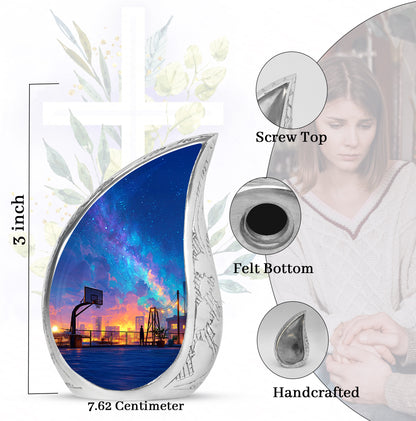 Dusty Blue Basketball Cremation Urn angled view of lid and engraved motif - rounded teardrop basketball design with delicate detail - mini keepsake memorial for portion of cremation ashes