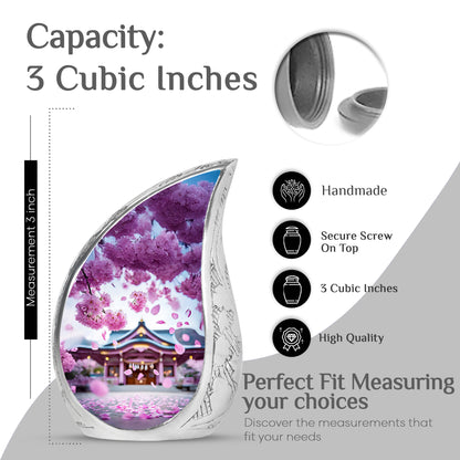 Blush Pink Cherry Blossom Cremation Urn angled view of lid and engraved motif - flowing teardrop cherry blossom silhouette on curved aluminum - mini keepsake memorial for portion of cremation ashes