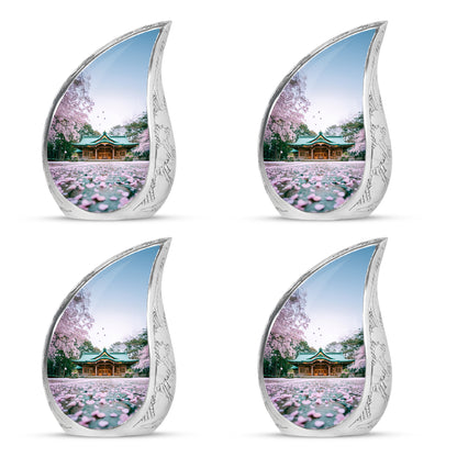 Ivory White Cherry Blossom Cremation Urn close-up of engraving and surface detail - rounded teardrop cherry blossom design with delicate detail - 10 inch aluminum urn for cremated remains
