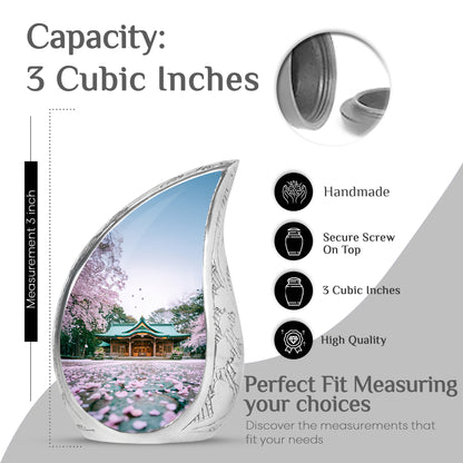 Frost White Cherry Blossom Cremation Urn angled view of lid and engraved motif - flowing teardrop cherry blossom silhouette on curved aluminum - mini keepsake memorial for portion of cremation ashes