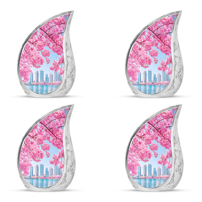 Cornflower Blue Cherry Blossom Cremation Urn close-up of engraving and surface detail - graceful tear-shaped urn with cherry blossom motif - 10 inch aluminum urn for cremated remains