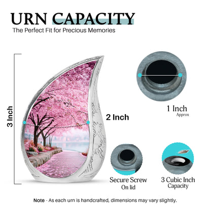 Coral Pink Cherry Blossom Cremation Urn angled view of lid and engraved motif - flowing teardrop cherry blossom silhouette on curved aluminum - mini keepsake memorial for portion of cremation ashes