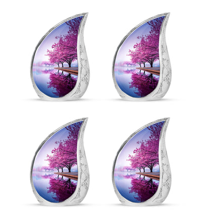 Snow White Cherry Blossom Cremation Urn close-up of engraving and surface detail - flowing teardrop cherry blossom silhouette on curved aluminum - 10 inch aluminum urn for cremated remains