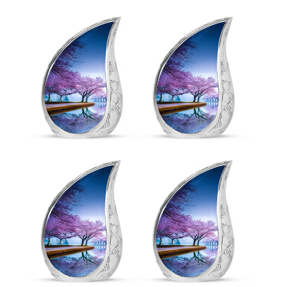 Powder Blue Cherry Blossom Cremation Urn close-up of engraving and surface detail - flowing teardrop cherry blossom silhouette on curved aluminum - 10 inch aluminum urn for cremated remains