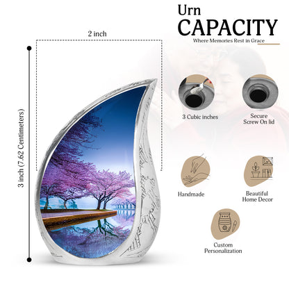 Calming Blue Cherry Blossom Cremation Urn angled view of lid and engraved motif - graceful tear-shaped urn with cherry blossom motif - mini keepsake memorial for portion of cremation ashes
