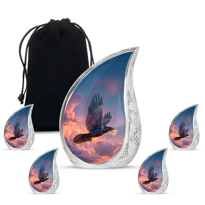 Slate Blue Crow Cremation Urn side profile showing urn shape - flowing teardrop crow silhouette on curved aluminum - memorial set with one large and four small urns