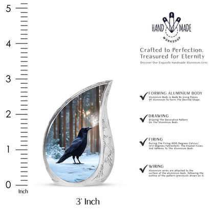 Sky Blue Crow Cremation Urn angled view of lid and engraved motif - flowing teardrop crow silhouette on curved aluminum - mini keepsake memorial for portion of cremation ashes