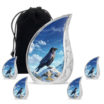 Icy Blue Crow Cremation Urn side profile showing urn shape - flowing teardrop crow silhouette on curved aluminum - memorial set with one large and four small urns