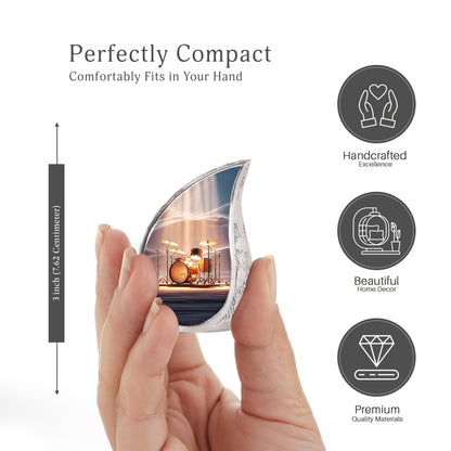 Steel Blue Drums Cremation Urn angled view of lid and engraved motif - smooth teardrop contour featuring drums art - mini keepsake memorial for portion of cremation ashes