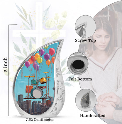 Serene Blue Drums Cremation Urn angled view of lid and engraved motif - smooth teardrop contour featuring drums art - mini keepsake memorial for portion of cremation ashes