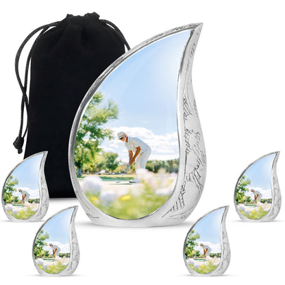 Satin Silver Golf Cremation Urn side profile showing urn shape - flowing teardrop golf silhouette on curved aluminum - memorial set with one large and four small urns