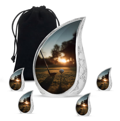 Gilded Gold Golf Cremation Urn side profile showing urn shape - flowing teardrop golf silhouette on curved aluminum - memorial set with one large and four small urns