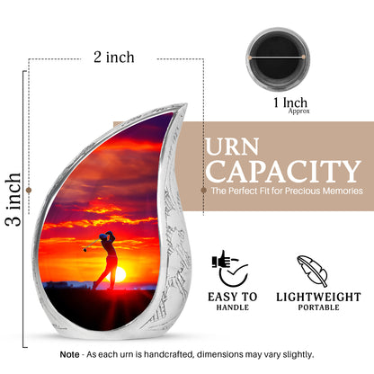 Fiery Red Golf Cremation Urn angled view of lid and engraved motif - smooth teardrop contour featuring golf art - mini keepsake memorial for portion of cremation ashes