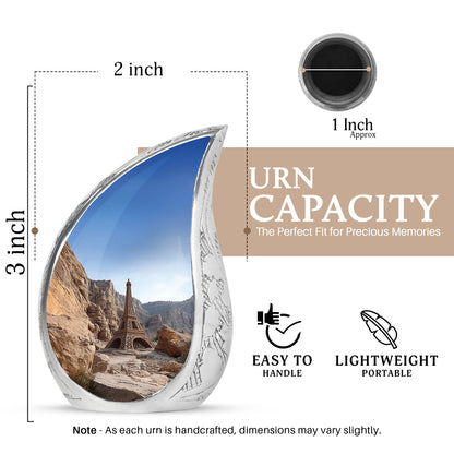 Steel Blue Eiffel Tower Cremation Urn angled view of lid and engraved motif - smooth teardrop contour featuring eiffel tower art - mini keepsake memorial for portion of cremation ashes