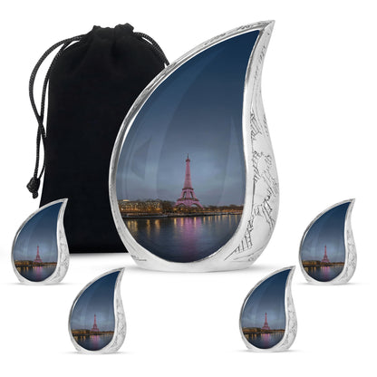 Indigo Eiffel Tower Cremation Urn side profile showing urn shape - flowing teardrop eiffel tower silhouette on curved aluminum - memorial set with one large and four small urns