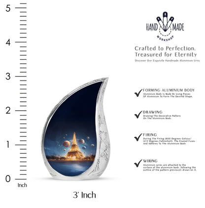 Misty Blue Eiffel Tower Cremation Urn angled view of lid and engraved motif - flowing teardrop eiffel tower silhouette on curved aluminum - mini keepsake memorial for portion of cremation ashes