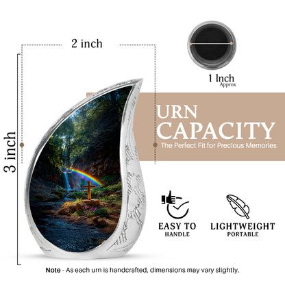 Midnight Black Cross Cremation Urn angled view of lid and engraved motif - smooth teardrop contour featuring cross art - mini keepsake memorial for portion of cremation ashes