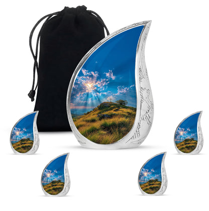 Sky Blue Cross Cremation Urn side profile showing urn shape - flowing teardrop cross silhouette on curved aluminum - memorial set with one large and four small urns