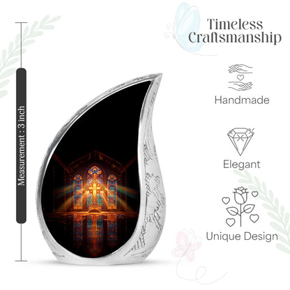 Deep Red Cross Cremation Urn angled view of lid and engraved motif - rounded teardrop cross design with delicate detail - mini keepsake memorial for portion of cremation ashes