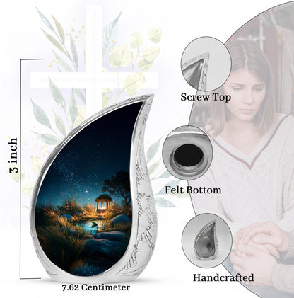 Sapphire Blue Frog Cremation Urn angled view of lid and engraved motif - smooth teardrop contour featuring frog art - mini keepsake memorial for portion of cremation ashes