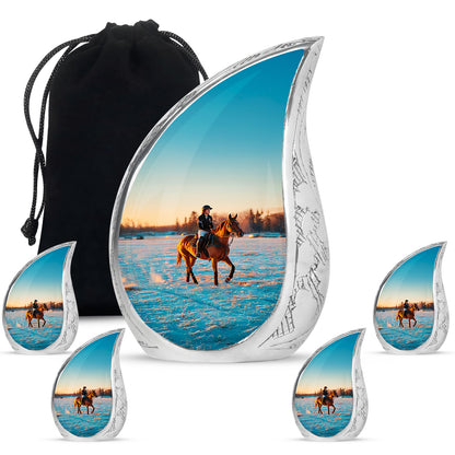 Gleaming Silver Horse Polo Cremation Urn side profile showing urn shape - flowing teardrop horse polo silhouette on curved aluminum - memorial set with one large and four small urns