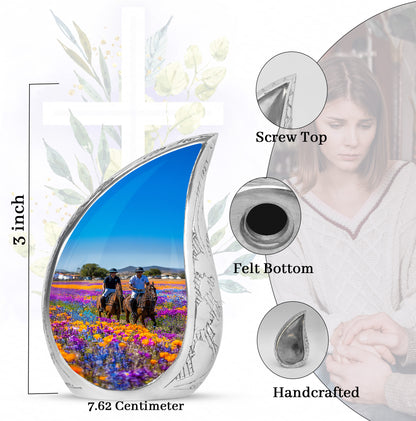 Vivid Blue Horse Polo Cremation Urn angled view of lid and engraved motif - graceful tear-shaped urn with horse polo motif - mini keepsake memorial for portion of cremation ashes