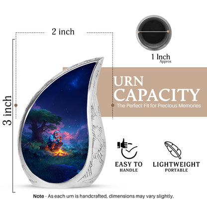 Soft Blue Campfire Cremation Urn angled view of lid and engraved motif - smooth teardrop contour featuring campfire art - mini keepsake memorial for portion of cremation ashes