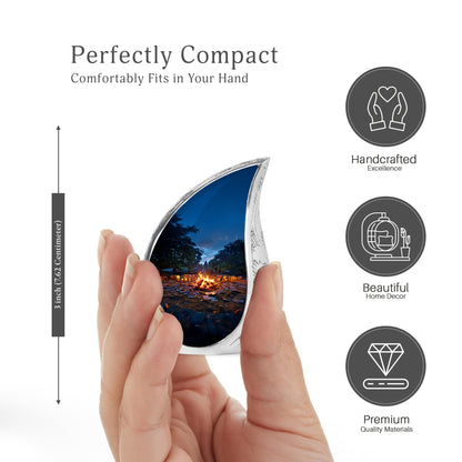 Vivid Blue Campfire Cremation Urn angled view of lid and engraved motif - smooth teardrop contour featuring campfire art - mini keepsake memorial for portion of cremation ashes