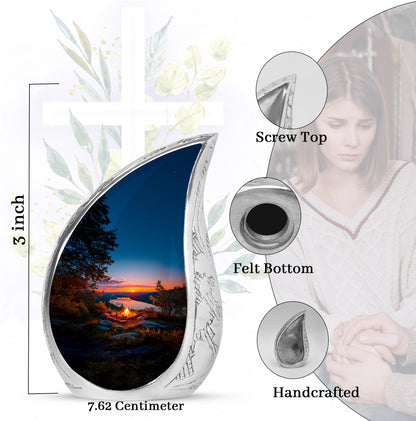 Cornflower Blue Campfire Cremation Urn angled view of lid and engraved motif - smooth teardrop contour featuring campfire art - mini keepsake memorial for portion of cremation ashes