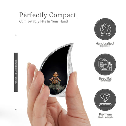 Midnight Black Halloween Cremation Urn angled view of lid and engraved motif - smooth teardrop contour featuring halloween art - mini keepsake memorial for portion of cremation ashes
