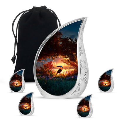 Garnet Red Hornbill Cremation Urn side profile showing urn shape - flowing teardrop hornbill silhouette on curved aluminum - memorial set with one large and four small urns