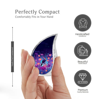 Cornflower Blue Hornbill Cremation Urn angled view of lid and engraved motif - smooth teardrop contour featuring hornbill art - mini keepsake memorial for portion of cremation ashes
