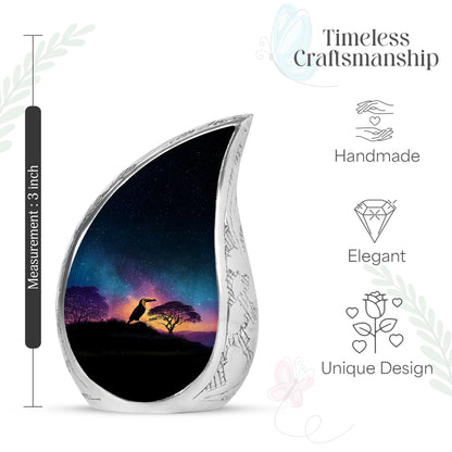 Celestial Blue Hornbill Cremation Urn angled view of lid and engraved motif - flowing teardrop hornbill silhouette on curved aluminum - mini keepsake memorial for portion of cremation ashes