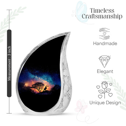 Pastel Blue Hornbill Cremation Urn angled view of lid and engraved motif - flowing teardrop hornbill silhouette on curved aluminum - mini keepsake memorial for portion of cremation ashes