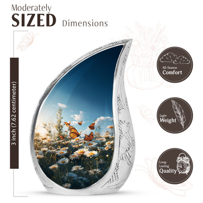 Slate Blue Daisy Cremation Urn angled view of lid and engraved motif - rounded teardrop daisy design with delicate detail - mini keepsake memorial for portion of cremation ashes