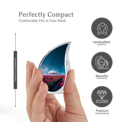 Calming Blue Garden Tulip Cremation Urn angled view of lid and engraved motif - smooth teardrop contour featuring garden tulip art - mini keepsake memorial for portion of cremation ashes