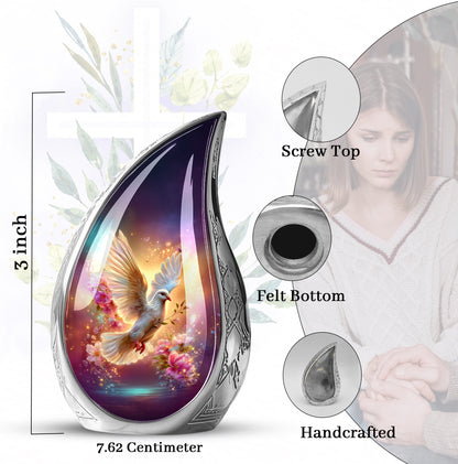 Pastel Blue Dove Cremation Urn angled view of lid and engraved motif - flowing teardrop dove silhouette on curved aluminum - mini keepsake memorial for portion of cremation ashes