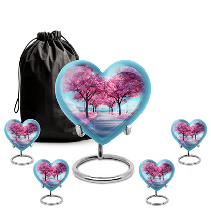 Cobalt Blue Cherry Blossom Cremation Urn close-up of engraving and surface detail - compassionate heart-cherry blossom combination with gentle curves - memorial set with one large and four small urns