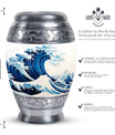 Large, white, decorative cremation urn for men with ocean waves design, suitable for adult ashes