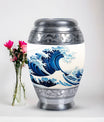 Large, white, decorative cremation urn for men with ocean waves design, suitable for adult ashes
