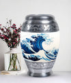 Large, white, decorative cremation urn for men with ocean waves design, suitable for adult ashes