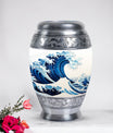 Large, white, decorative cremation urn for men with ocean waves design, suitable for adult ashes