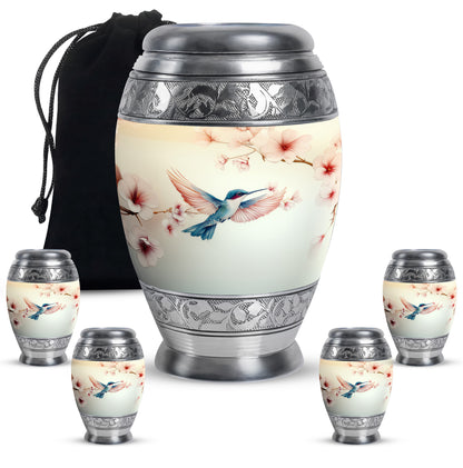 Ivory White Hummingbird Cremation Urn detail view - ornate monarch-style hummingbird relief on brushed aluminum - memorial set with one large and four small urns
