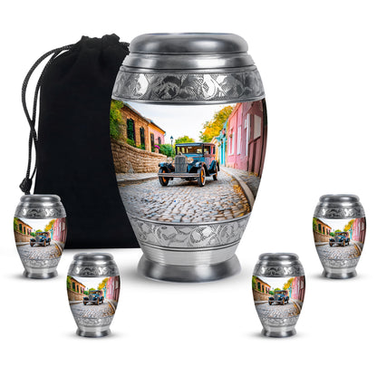 Pure White Car Cremation Urn detail view - ornate monarch-style car relief on brushed aluminum - memorial set with one large and four small urns