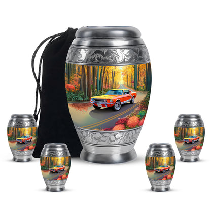 Champagne Gold Car Cremation Urn detail view - ornate monarch-style car relief on brushed aluminum - memorial set with one large and four small urns