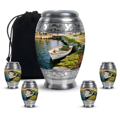 Amber Yellow Boat Cremation Urn detail view - ornate monarch-style boat relief on brushed aluminum - memorial set with one large and four small urns